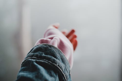 Free Person in Denim Jacket With Hand Reaching Out Stock Photo