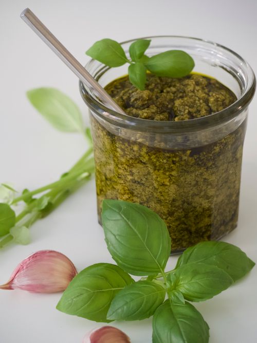 Free Close-up of homemade basil pesto in a glass jar, featuring fresh ingredients. Stock Photo