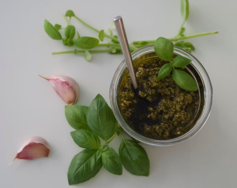 Overhead shot of homemade basil pesto with garlic and fresh basil — photo by thea a on Pexels