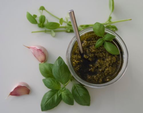 Free Overhead shot of homemade basil pesto with garlic cloves and fresh basil leaves. Stock Photo