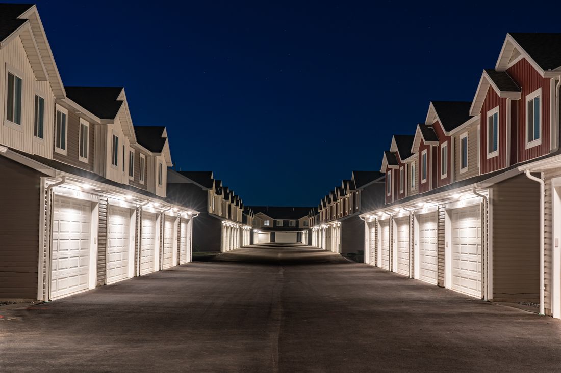 Well-lit residential area featuring rows of modern townhouses at night in Hyrum