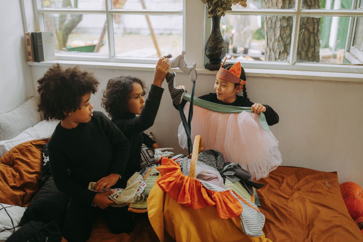 Children looking through costumes and playing dress-up.