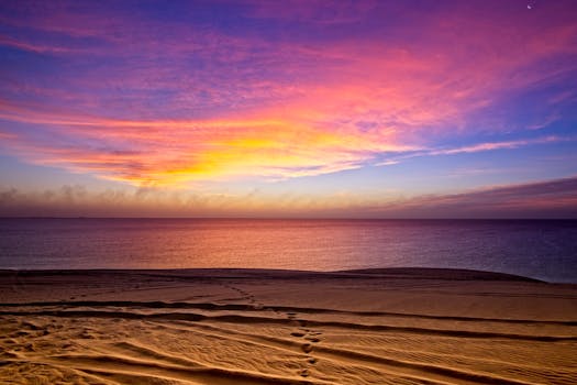 A breathtaking sunrise at Umm Said beach in Qatar with colorful skies and serene ocean waves.