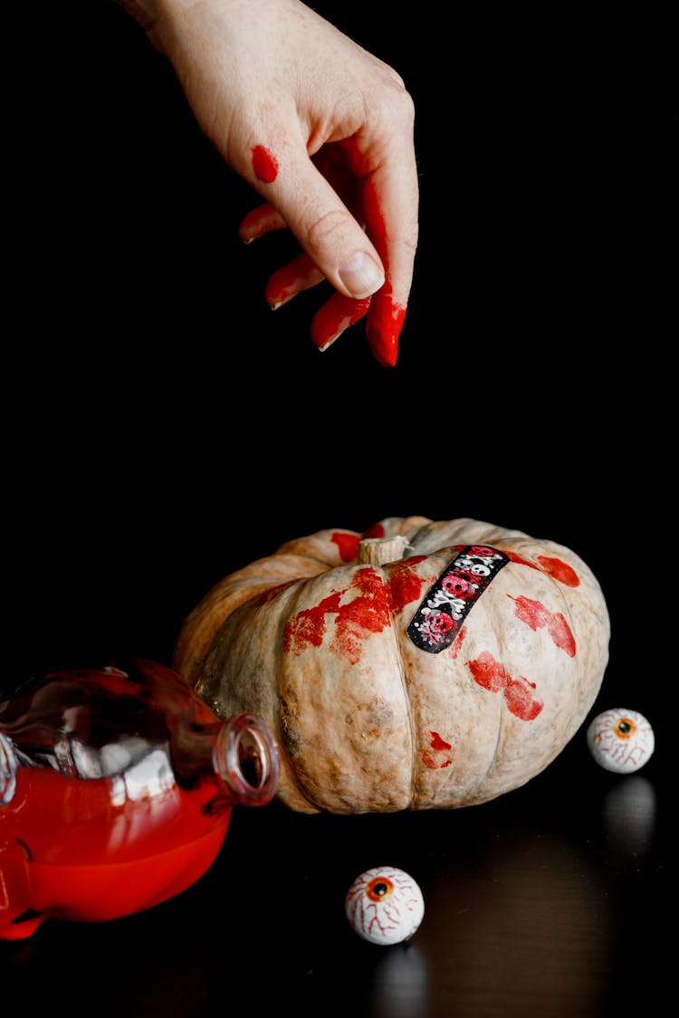 A Bloody Hand Over A Pumpkin