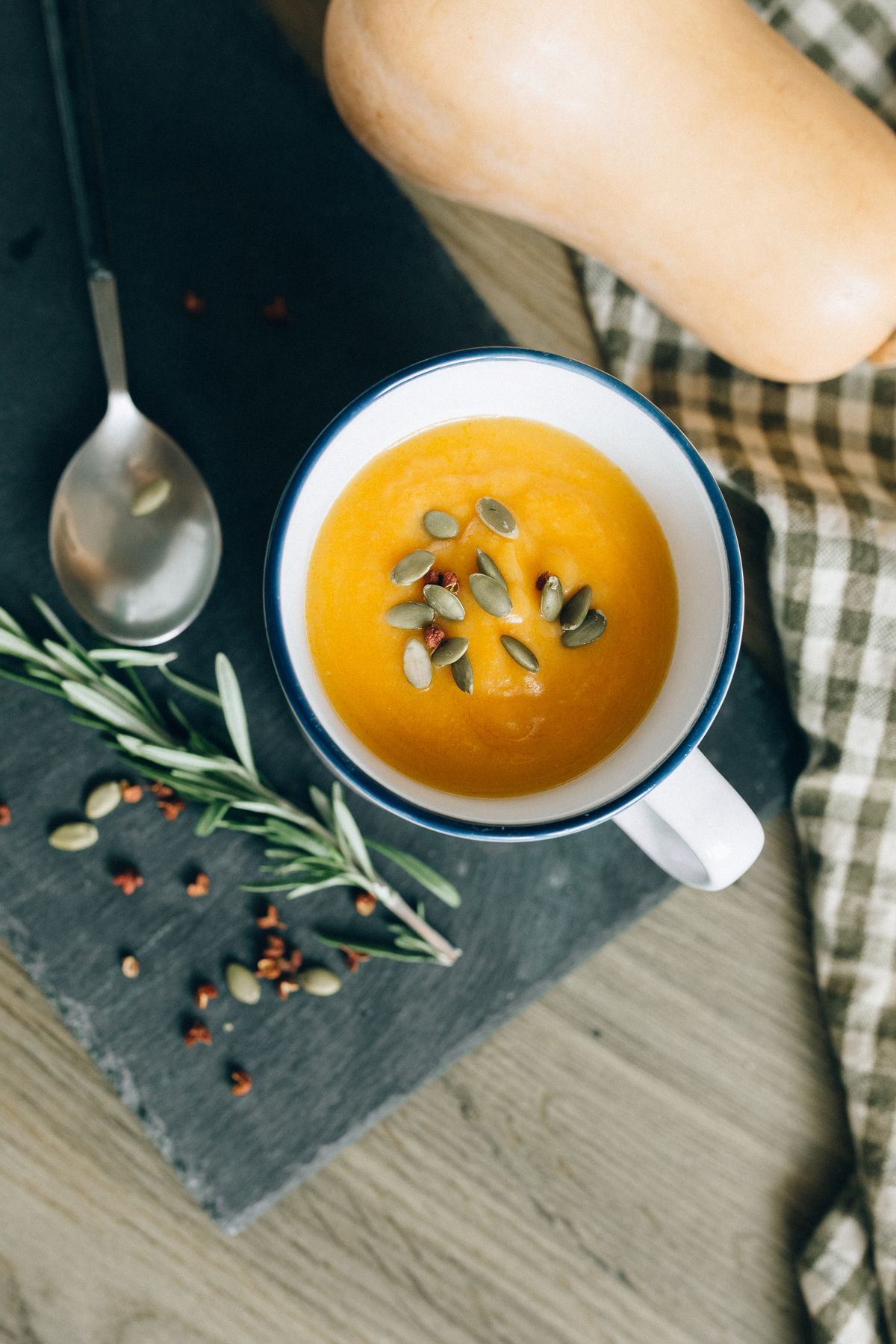 A bowl of soup topped with seeds in a cozy setting