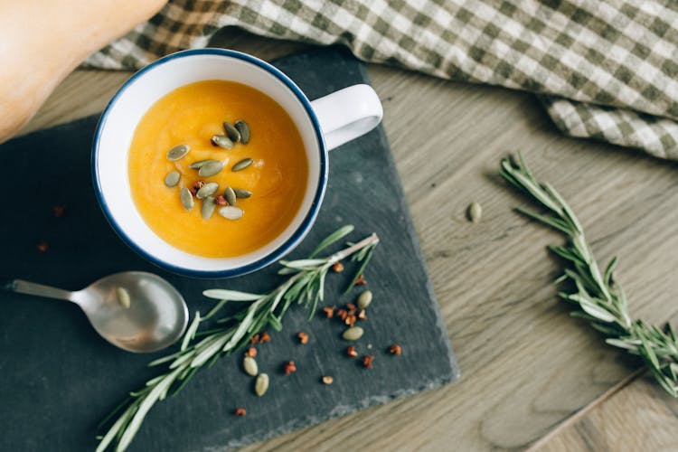 Overhead Shot Of Pumpkin Soup In A Mug