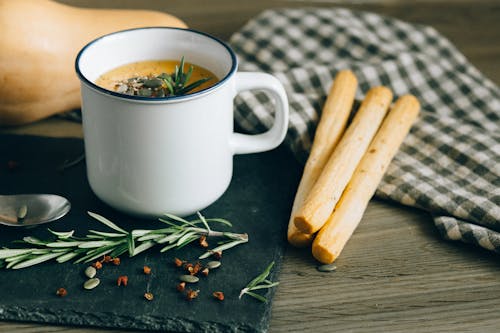 Free Pumpkin Soup in a Mug and Breadsticks Stock Photo