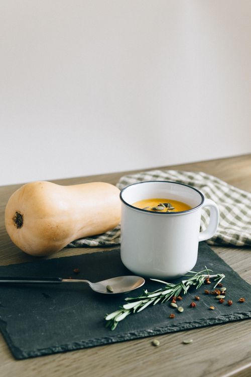 Free Warm and cozy butternut squash soup served in a rustic mug, perfect for autumn meals. Stock Photo