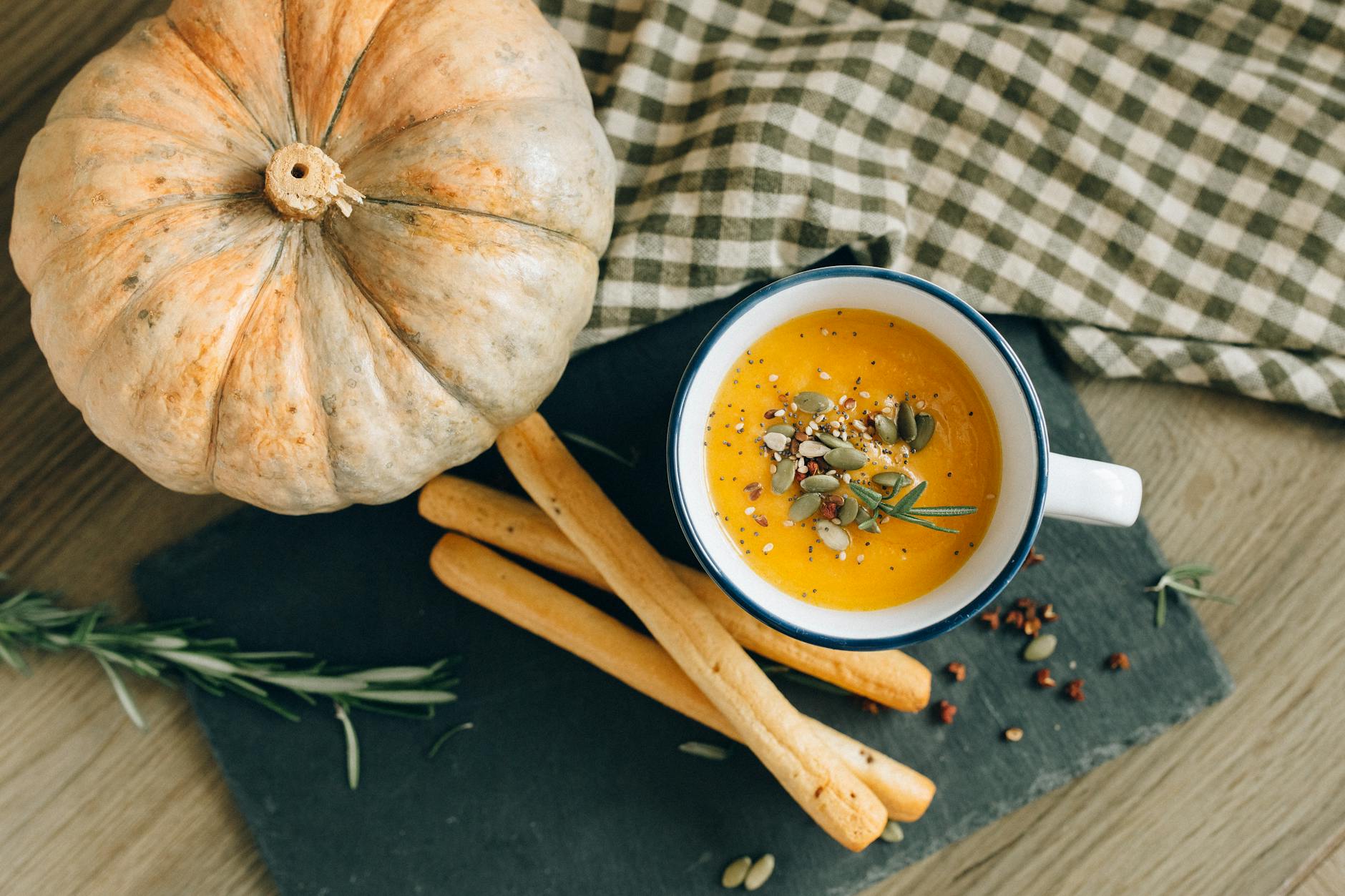 https://www.pexels.com/photo/overhead-shot-of-bread-sticks-and-pumpkin-soup-5605535/