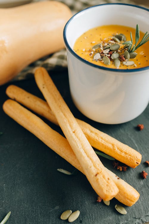 Free Close-up of Bread Sticks and Pumpkin Soup Stock Photo
