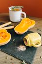 White Ceramic Mug Beside Brown Wooden Rolling Pin