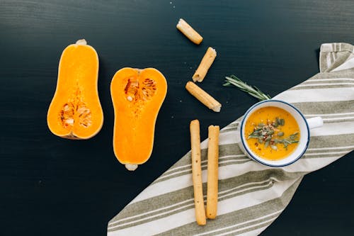 Sliced Orange Fruit on Black Wooden Table