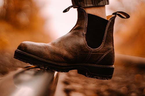 A Person Wearing a Leather Boot 