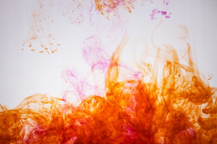 Orange and pink ink swirling in water by Engin Akyurt on Pexels