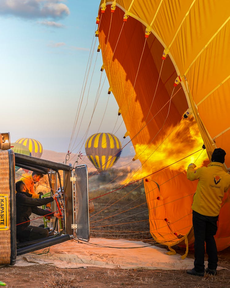 Group Of People Launching Hot Air Balloons