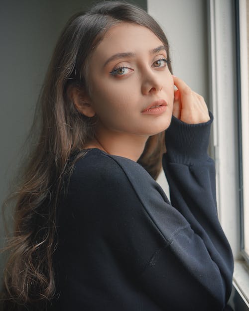 Portrait of Beautiful Woman in Black Sweater 