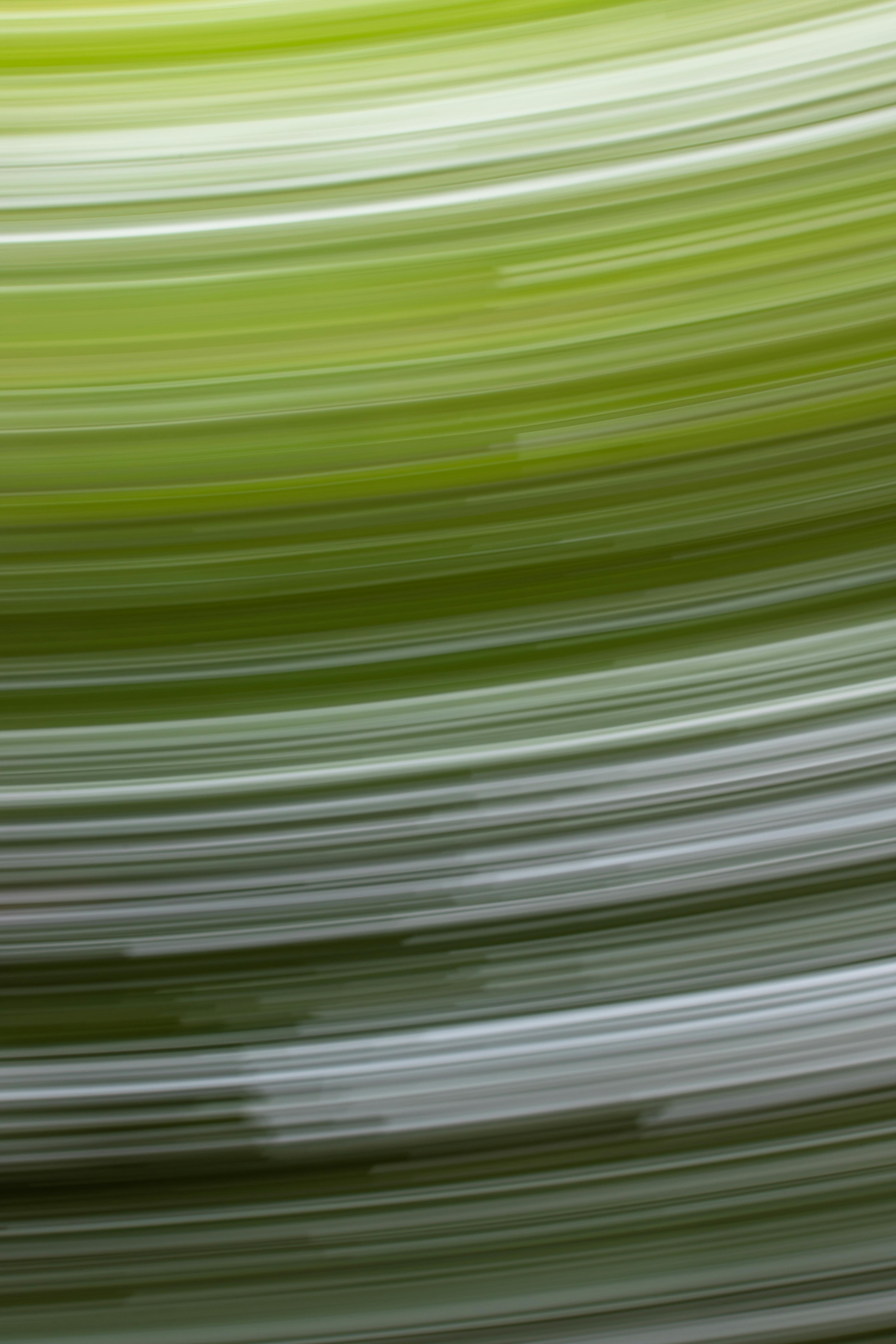 Dynamic abstract background with green motion blur creating a sense of movement and energy.