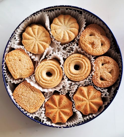 Free Top view of assorted Danish butter cookies in a decorative tin, perfect for snacking. Stock Photo