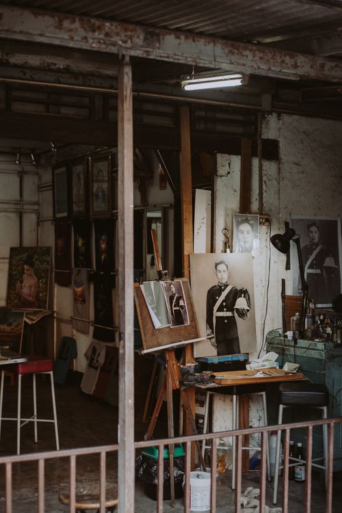 Free A cozy artist's studio filled with portraits and artwork, showcasing a creative workspace. Stock Photo