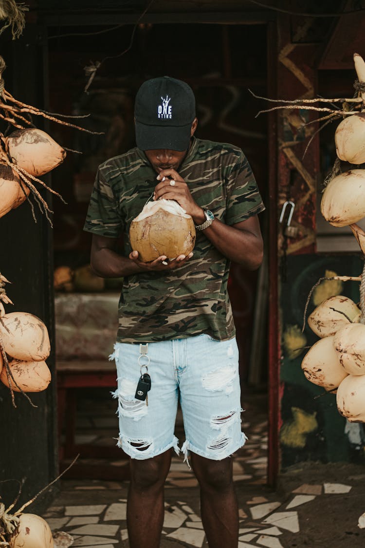 Black Man Drinking Coconut Water