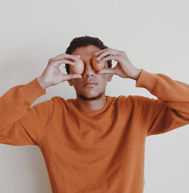 A Man In Orange Crew Neck Long Sleeve Shirt