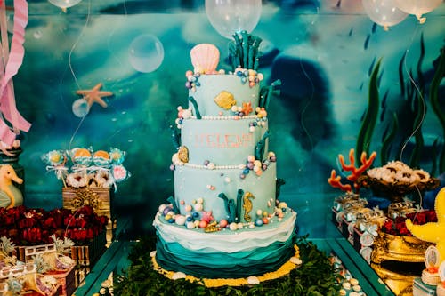 Birthday cake and desserts on table