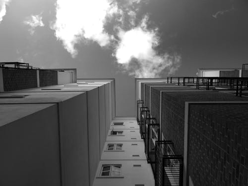 Grayscale and Low Angle Photography of High-rise Buildings