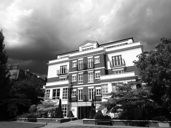 Classic London apartment building under dramatic sky, representing enveloped UK residential property held by a company