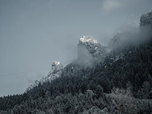Snow Covered Mountain Under Foggy Sky
