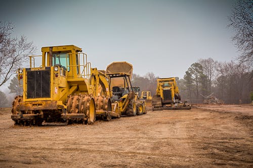 Yellow and Black Heavy Equipment on Brown Field