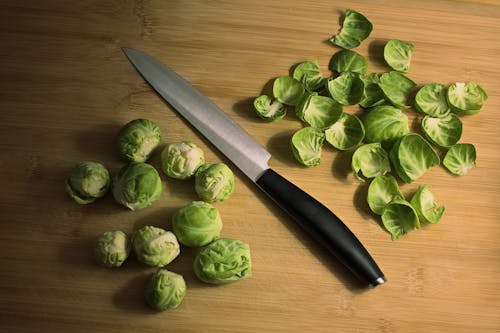 Free Knife with green Brussels sprouts Stock Photo
