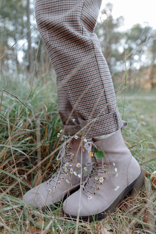 Person in Gray Boots Standing on Green Grass