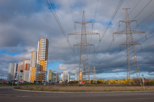 Electrical Posts And Power Lines Under Cloudy Sky