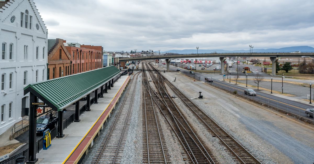 Elevated view of Roanoke train station with railway tracks, showcasing urban transportation infrastructure.
