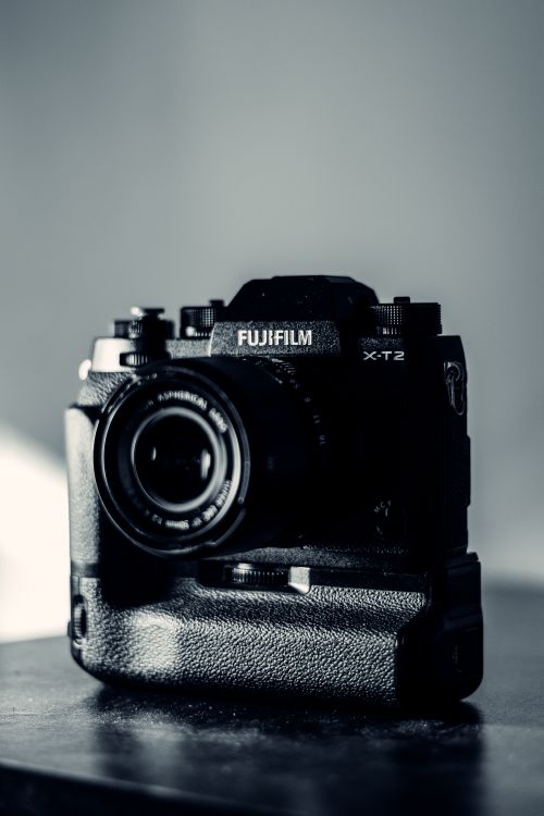 Free Black and white of contemporary device with small round lens on table in daytime Stock Photo