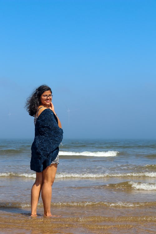 Smiling Woman Standing On The Shore Looking At Camera