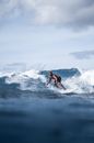 Energetic black man surfing on board on azure seawater