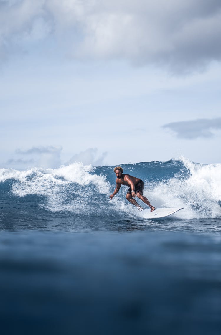 Energetic Black Man Surfing On Board On Azure Seawater