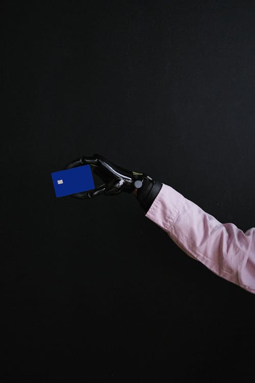 Person in Pink Long Sleeve Shirt Holding Black Smartphone