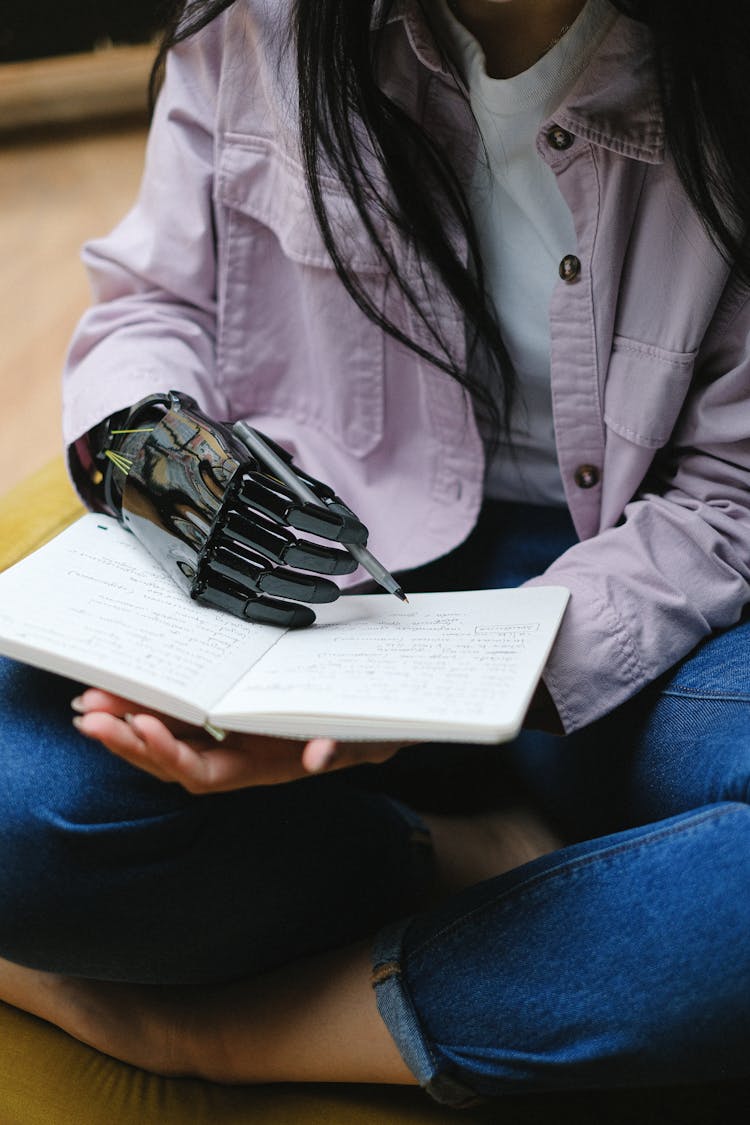 Person With Bionic Arm Writing