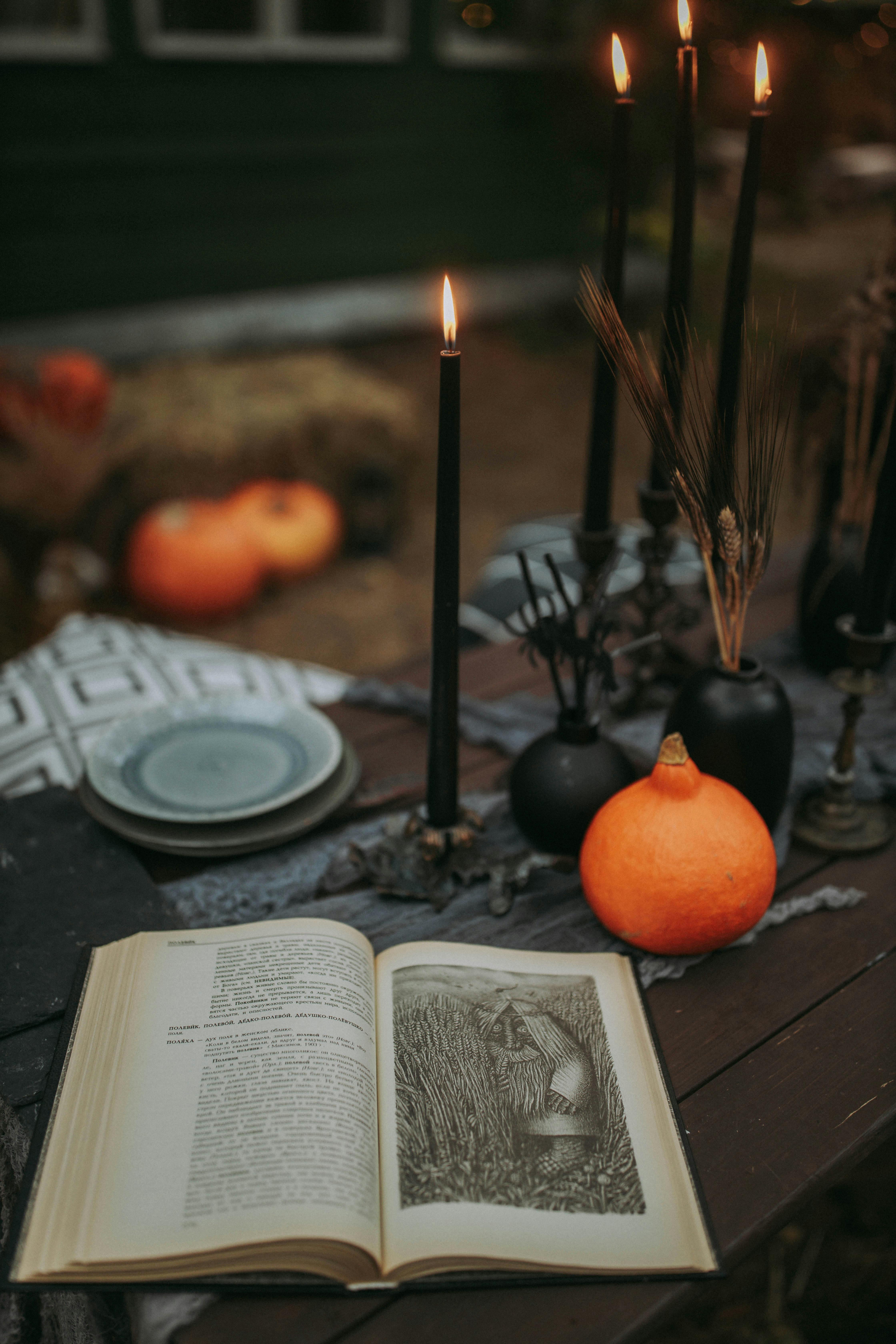 spell book with lighted black candles