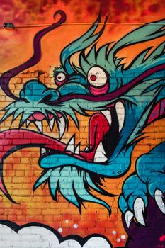 Eye-catching dragon mural art in Coeur d'Alene, Idaho, showcasing vibrant graffiti style.