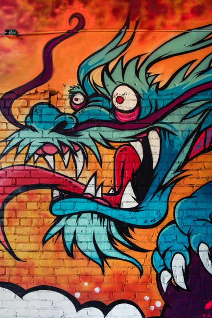 Eye-catching dragon mural art in Coeur d'Alene, Idaho, showcasing vibrant graffiti style.