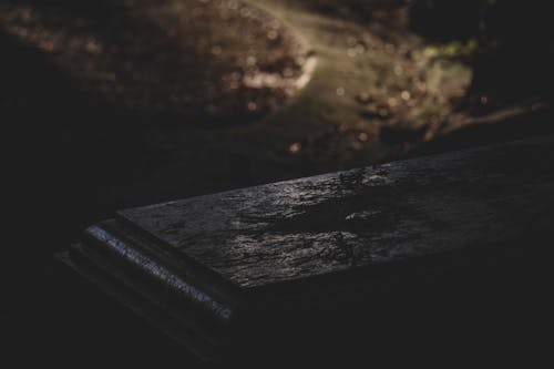 Free Old tombstone in dark cemetery at night Stock Photo