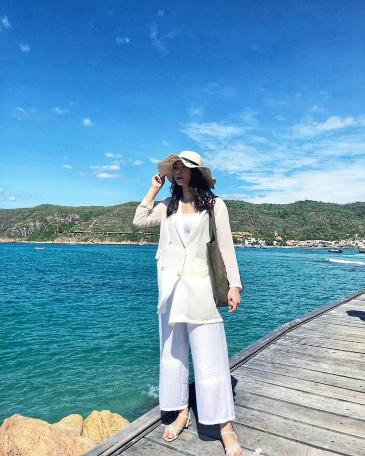 Customer holding shopping basket while waiting near a store display