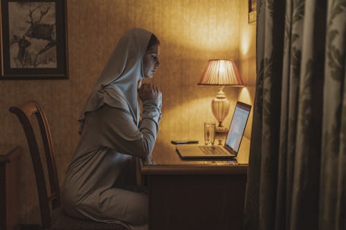 Free A Woman Using a Laptop at Home Stock Photo