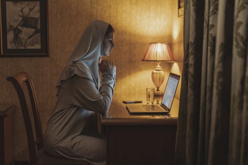 Man working at home using laptop near the big window. Remote work, online  job, work from home. Stock Photo