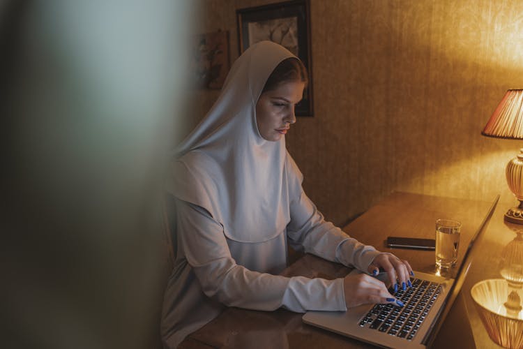 Woman In White Hijab Using Laptop Computer