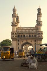 Street view of the Charminar monument in Hyderabad with people and vendors