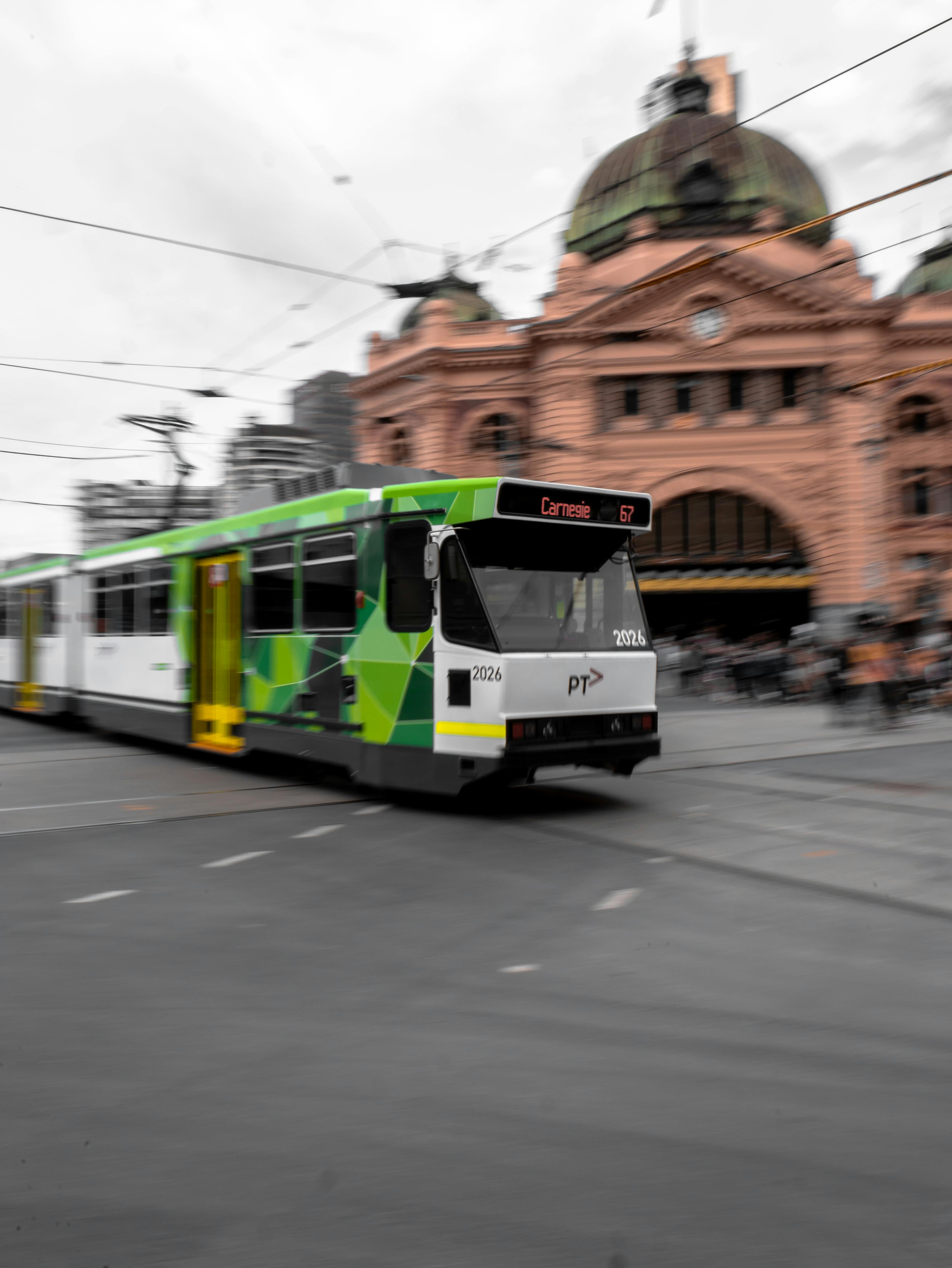 white and green tram on road